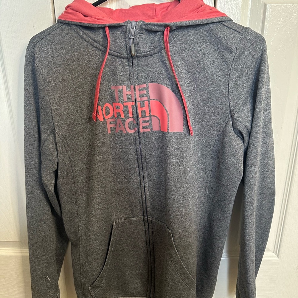 Dark grey north face jacket with pink letters